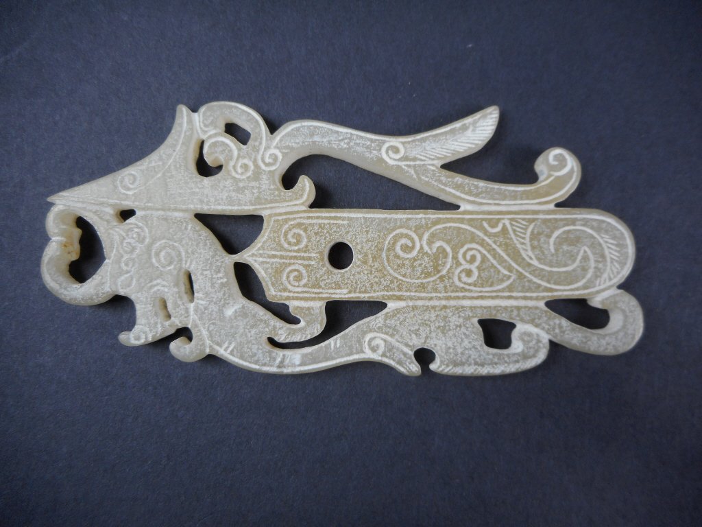 Jade Pendant, Han Dynasty (206 BC-220 AD): White jade pendant in the form of a dragon and phoenix with incised heart designs. Diffuse calcification. Han Dynasty (206 BC-220 AD) unearthed in Xi'an, Shaanxi Province. 4"L