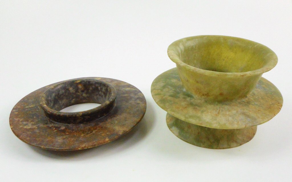 Archaic Collared Jade Discs: Two collared jade discs with smooth surfaces, russet and dark brown suffusion, and slight areas of loss due to erosion. 5.5"_x000D_