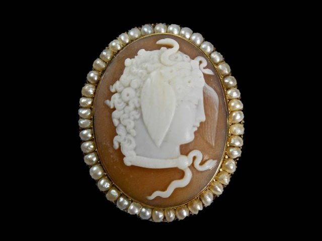 14K Gold Victorian "Medusa" Shell Cameo: Heavy gold setting with pin back. Forty-one pearl border and shell cameo panel with detailed profile portrait of Medusa. 1.5", 10.7g, 6.8 Dwt
