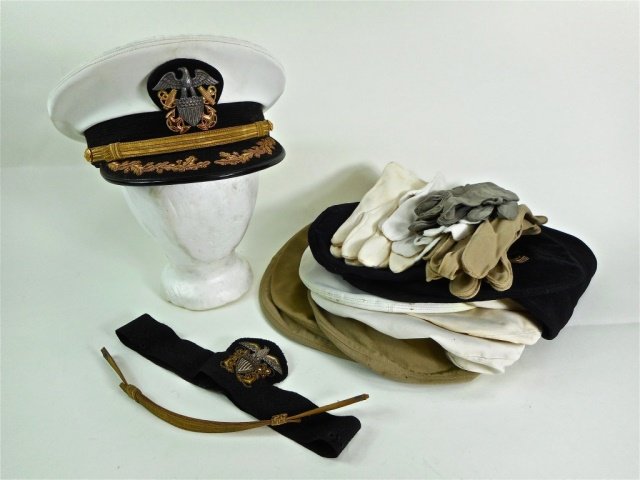 WWII Headgear and Accessories (22 pcs): Collection of WWII headgear and accessories, belonging to Captain Roland W. Holmes U.S.N., including: one U.S. Navy Captain's cap with white cover, four white tops, three navy blue tops, three khaki t