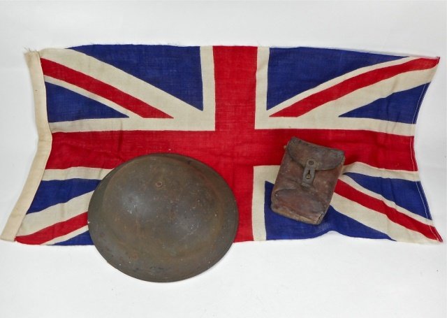 WWI Era Helmet, Flag and Ammo Pouch: U.S. doughboy type helmet. Pouch is leather and likely Austrian. Wool flag is Union Jack. Wear consistent with age and use.
