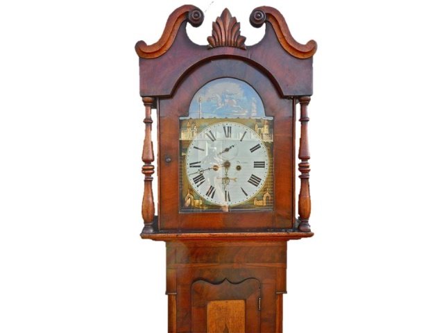 English Tall Clock, Arabesque Face, Durham: Circa 1800 English tall clock. Wide oak and mahogany case with supporting columns, glazed bonnet with shell finial, pendulum decorated with thistle. Face carries hand painted scene of Arabian figure o