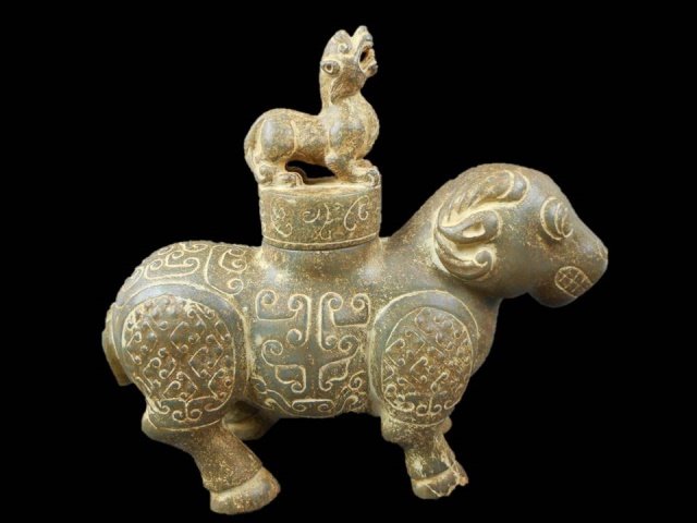Chinese Jade Vessel, Ox: Jade lidded vessel in the form of an ox with geometric and anthropomorphic mask designs. Finial is fashioned as a lion. Provenance: Private Massachusetts collection. Unearthed in Xi'an, Shaanxi Provin