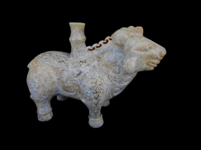 Chinese Jade Ox Figure: Green jade stylized ox with a bamboo shaft protruding from his back. Body carries detailed incised designs. Each leg features a coiled chilong carved in bas-relief. . 3"H x 4"W Provenance: Private Mas
