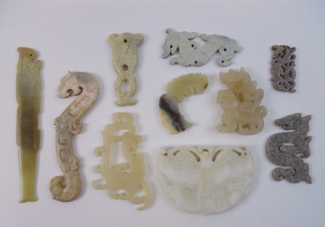 Chinese Jade and Stone Ornaments: Collection of ten Chinese jade and stone ornaments of various age and composition in openwork animal, stylized dragon and phoenix designs. Largest measures 5.5"L. Provenance: Private Massachusetts col