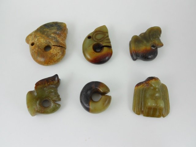 Chinese Jade Ornaments: Six Chinese jade ornaments in the form of pig dragons, a slit ring, and a bird. Largest measures 2.5"H. Provenance: Private Massachusetts collection.