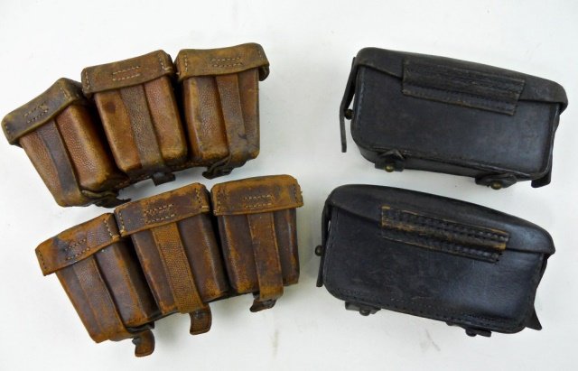 WWI German Ammunition Pouches (4pc): Pair of WWI 8mm ammunition pouches with pebbled brown leather and riveted belt and suspension loops, front closure straps and interior rawhide dividers. One maker marked, "CARL AKVA LEDERFABRIC KREOZN