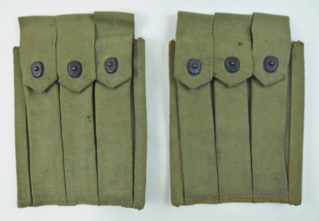 Pair WWII USMC Thompson MG Cartridge Pouches: Khaki web construction with three compartments and snap closure straps. Reverse with wide belt loop marked in ink, "U.S.M.C. B.M. CO. NOM. 49412 1944." 10.2" H x 7.3" W