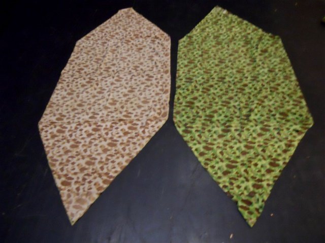 Two WWII USMC Camouflaged Shelter: WWII Double sided camouflaged fabric with ties, metal grommets and buttons for attachment. One side with green based pattern with brown and olive drab with two shades of green. Reverse with brown base