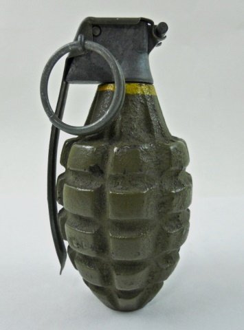 INERT WWII U.S. Mark II Hand Grenade: Cast iron body with olive drab paint, stamped "6D." Metal cap with hinged spoon secured by a bent wire ring pin. 4.75" H x 2.3" W