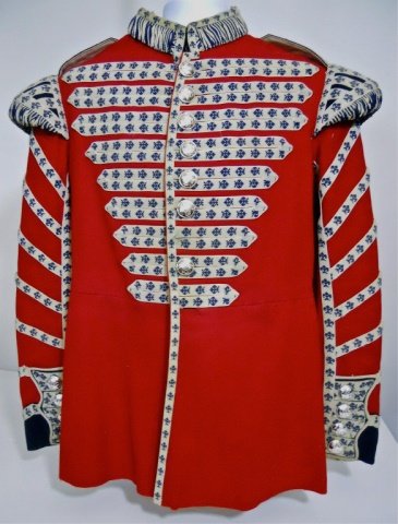 20th C. British Scotts Guards Bandsman's Tunic: Red wool construction with detailed fleurs de lis ribbon decoration and nine button front closure with stand up corded collar and shoulders. Detailed eight button rear tails with ribbon decoration and