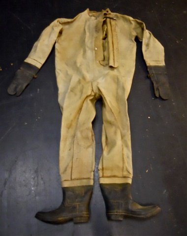 WWII USN Dive Suit, U.S. Rubber Co.: Heavy rubberized canvas construction, with attached rubber boots and gloves. Flap front five snap closure with double snap collar. Reverse with "USN" stencil, interior stamped in ink "MEDIUM CONTRACT