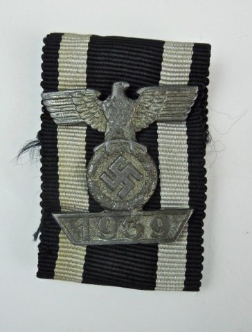 WWII German 2nd Klasse Spange with Ribbon, L/11: Die struck alloy spange with staple back. Silver washed alloy, spread wing eagle clutching canted, wreathed swastika over tableau with 1939 date. Reverse marked at center "L/11" on ribbed black and wh