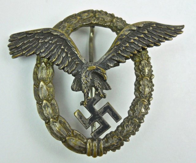 WWII German Luftwaffe Pilot Badge, Assman: Two piece die struck alloy badge with spun and dimpled rivets marked, "A" (Assman), on reverse wreath. Straight barrel pin with c-catch. Spread wing eagle clutching canted swastika on silver washed la