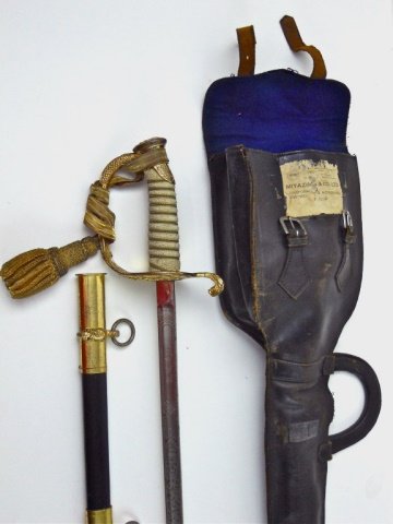 WWI Era U.S. Navy Officer's Sword, SWORD Co.: Gilt guard with reticulated oak leaves and "USN." Wire wrapped shagreen grip with bullion sword knot. Blade is triple edged with patriotic themes and personalization in panel, "R.T. Lynn." Ricasso is 