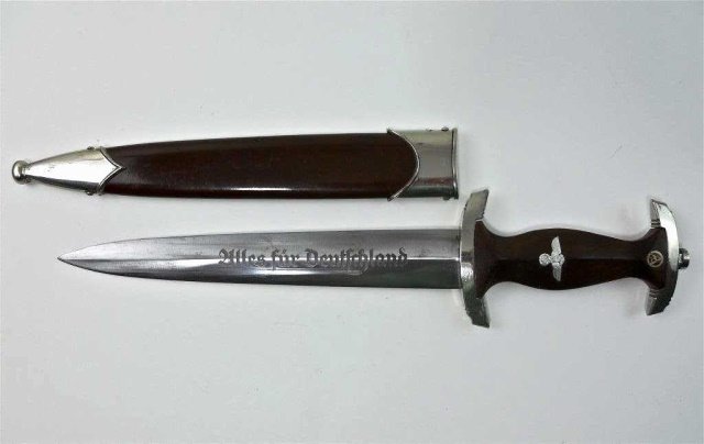 WWII German SA Dress Dagger, PUMA: RZM type with plated guards, wood grip with inset NSDAP eagle and enamel button. SA blade etched, "Alles fur Deutschland" in gothic script. Reverse marked, "RZM M7/27", (PUMA), scabbard with plated fi