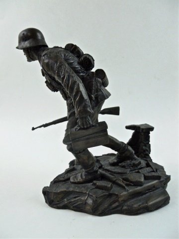 Cold Cast Bronze WWII German Soldier, Terry Jones: Cold cast bronze of highly detailed figure of a German soldier with rifle and gear marching over French helmet with signs and debris. 1940 Western offensive. 9" H x 6.2" W x 7.5" D