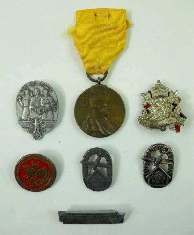 WWI and WWII German Medals and Pins (7pc): Mixed medals and insignia including Two "RLB" pins read "LUFTSCHUTNOT", One WWI Kaiser Medal with ribbon, One "DEUTCHER KRIEGER BUND" pin with ribbon, One "TAG DER ARBEIT" Pin dated 1935, One "WIR OPF
