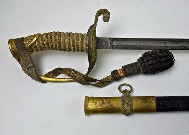USN Officer's Sword "J. KENT AVERILL", Horstmann: 1930's Era Model 1852 Officer's sword, with gilded brass, reticulated foliate guard with "USN" and wire wrapped shagreen grip. Blade is double etched with naval themes and is personalized with "J. KEN