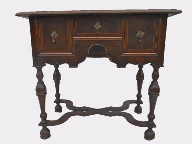 18th C. William & Mary Burl Dressing Table: William & Mary style lowboy with three dovetail constructed drawers with teardrop brass pulls. Burl veneer with herringbone border. Gothic arch apron over carved baluster legs and cross bracket. Some
