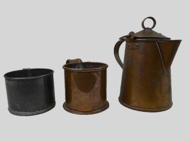 Civil War Copper Coffee Pot and Mugs (3pc): One officer grade copper lidded coffee pot, with swing handle and riveted handle. 9.5" H One copper coffee mug with riveted handle. 4.3" H One soldered tin coffee mug with flat bottom. 3.6" H