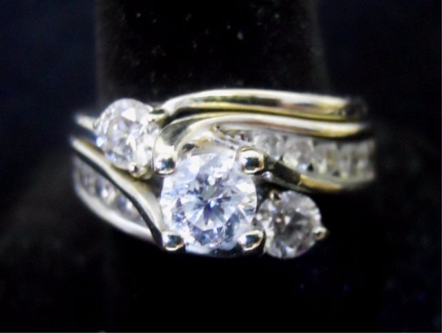 Two Integrated 14K White Gold and Diamond Rings: One 14K white gold diamond ring with one center round brilliant cut diamond weighing estimated .50cts, SI2 clarity and H color. Flanked by 10 channel set round brilliant cut diamonds, weighing .03cts.
