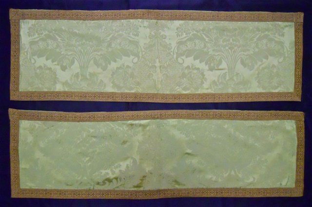 Two Antique Silk Damask Table Runners: Two table runners in antique green silk damask fabric with metallic border and silk lined reverse. Areas of wear consistent with age and use. Each measures 14.5" x 49".