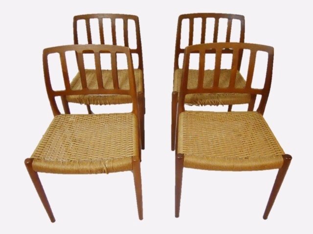 Danish Teak Dining Chairs, Neils O. Moller: Four Danish Mid-Century Modern teak chairs with rush seats designed by Niels O. Moller. Circa 1960's Losses to rush seats. Measurements 31" H x 19.5" W x 16" D.