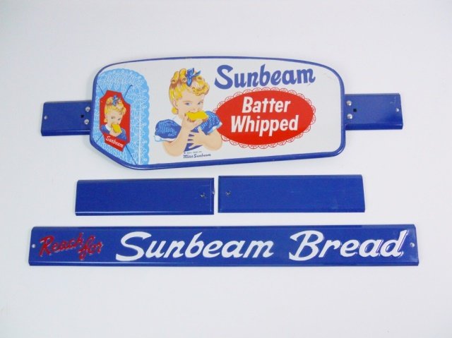 Vintage Sunbeam Door Pull Advertising Signs, NOS: Two vintage NOS tin color lithograph Sunbeam Bread door pull advertising signs, measuring 26.5" L x 8.5" W and 26" L x 5" W.