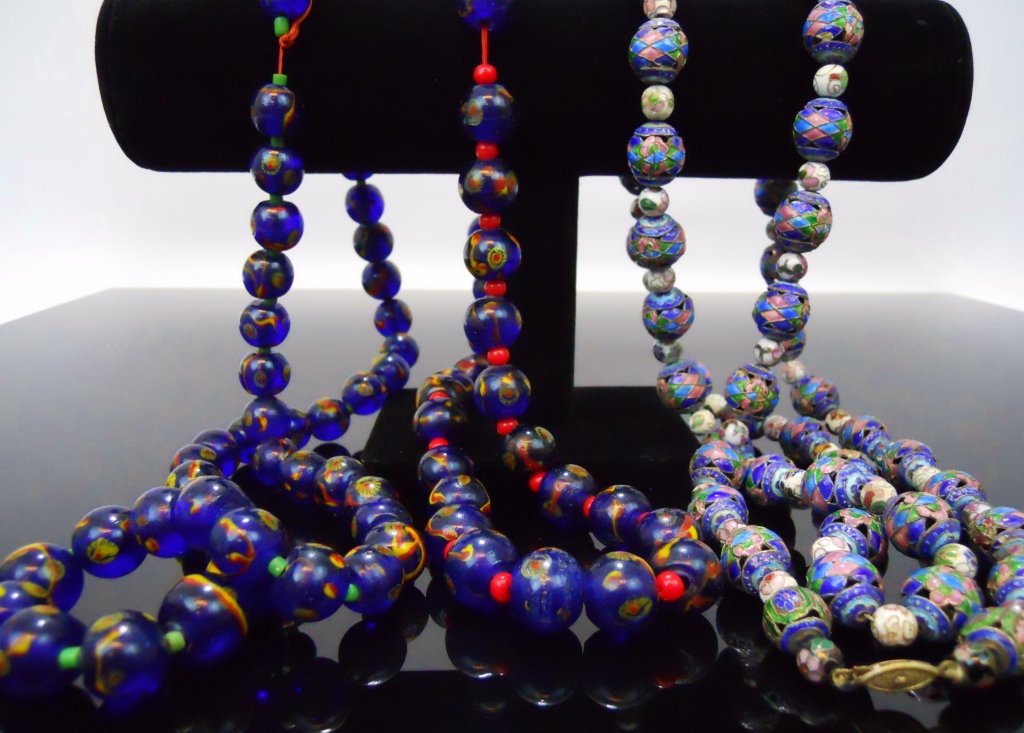 Antique Glass Bead & Cloisonne Necklaces: Two vintage cobalt blue Chinese glass mosaic bead necklaces on red silk cords, measuring 10" and 14" in length; together with two antique cloisonne beaded necklaces measuring 11" in length.