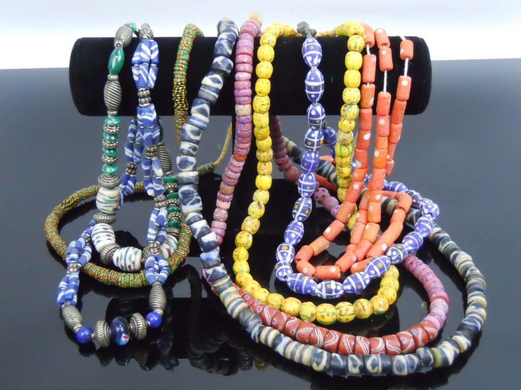 19th C. Venetian Glass African Trade Beads: Seven 19th C. Venetian glass African trade bead necklaces. Longest measures 13" in length. Additionally, two necklaces comprised of antique Venetian glass interspersed with decorative metal spacer bea