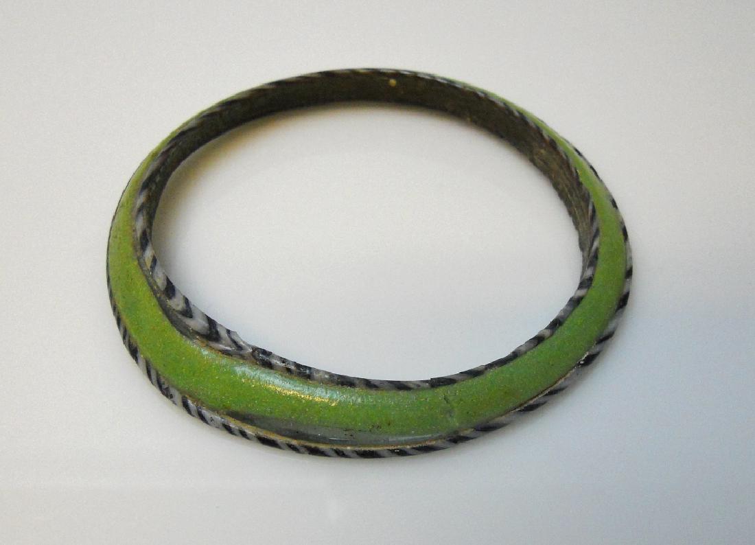 Ancient Roman Glass Bracelet, Augustan Period: Ancient Rome, Augustan Period, polychrome glass bracelet comprised of green glass flanked by bands of black and white. Measures 3.5" in diameter. PROVENANCE: From private Michigan collection.