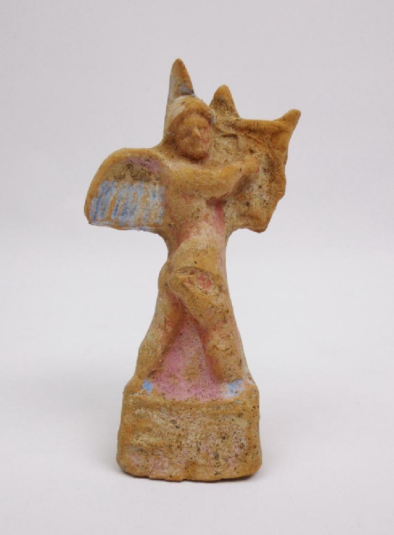 Ancient Greek Terracotta Figurine, Erote, 350 B.C.: Ancient Greek terracotta figurine of an Erote playing the kithera. Traces of white, blue and pink paint. Circa 350 B.C., Apulia, Magna Grecia. Surface degradation consistent with age. Measures 4.25" H