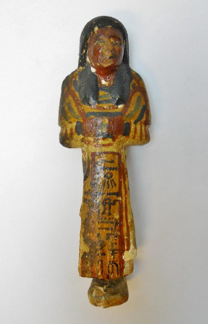 Egyptian, Wooden Foreman Ushabti, 19th-20th DYN: Rare ancient Egyptian Ushabti (funerary figurine) comprised of wood overlaid with gesso and polychrome paint. Vertical heiroglyph band inscribed, "Chief of the Cattle Stalls." New Kingdom, 19th-20th D