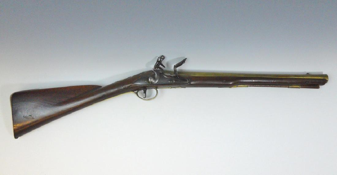 18th C. Flintlock Blunderbuss, H. Hadley, London: English Flintlock Blunderbuss with swamped barrel in brass signed, "H. HADLEY CHARING CROSS LONDON" in oval cartouche. Stamped London proofs and foliate engraved decoration. Steel lock with gooseneck