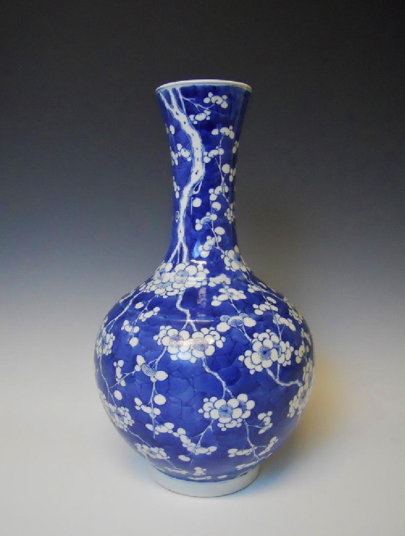 Chinese Blue & White Prunus Vase, Kangxi Period: China, Kangxi Period (1661-1722) - Prunus flower globular form vase in blue and white, bearing late Kangxi Period six- character kaishu mark at bottom. Small flake at rim. Measures 16" H.