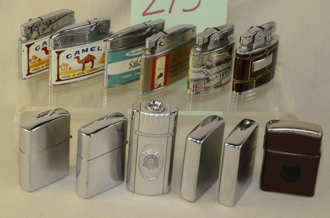 Lot of 12 Cigarette Lighters Vintage: Hilite, Reliance, Zippo, Champ, Penguin Salem, 2 ZenithCamels, Kent, Prince, WellingtonBalboa advertising, Partner pistol shaped. Sold as found.
