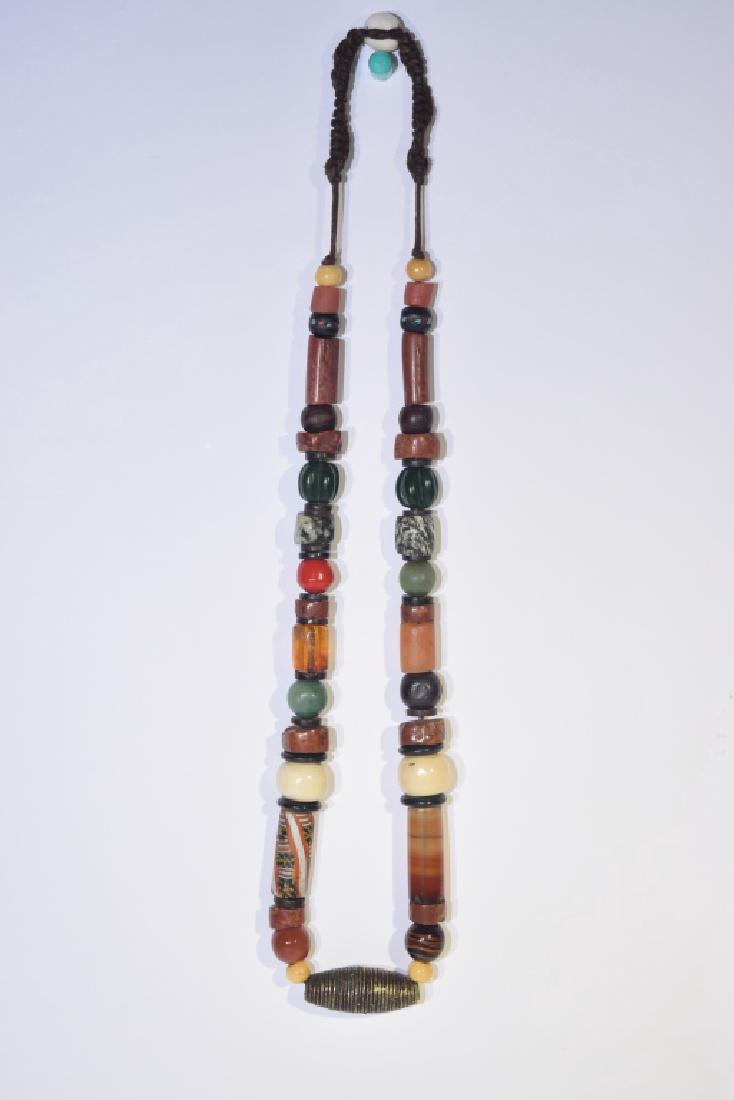Tibetan Glass and Precious Stone Bead Necklace: Tibetan glass and precious stone bead necklace. 14in. Age wear.