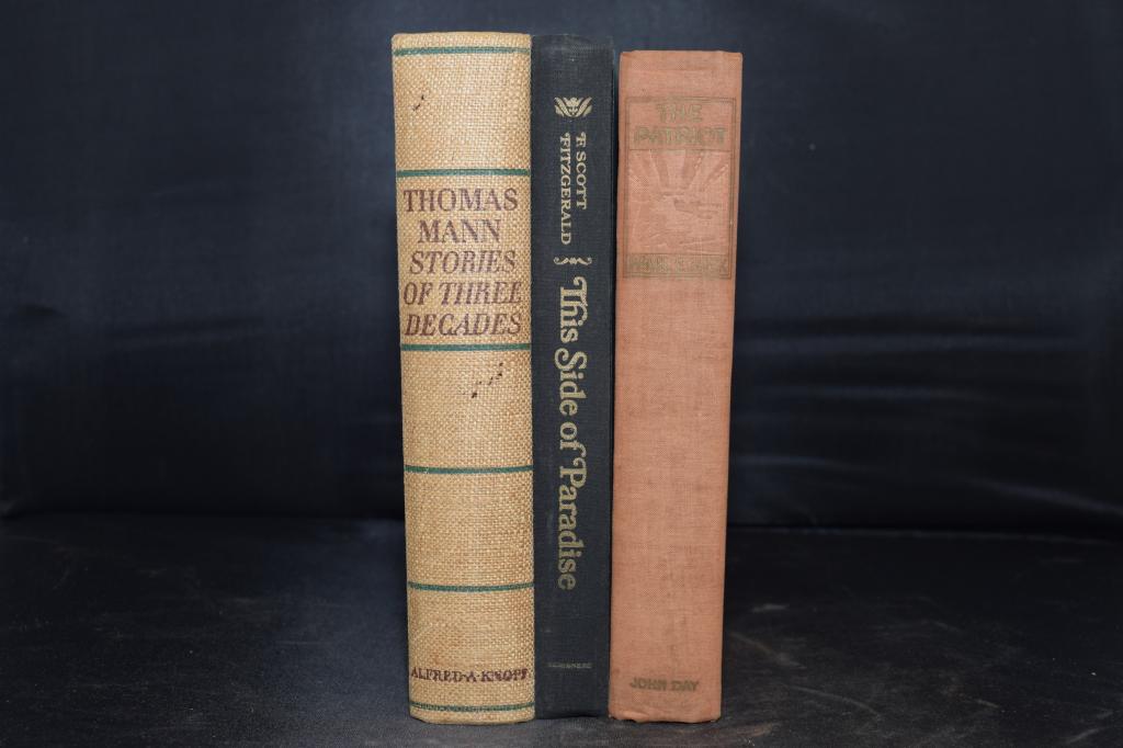 Collection of Books: This Side of Paradise: Collection of Books: Thomas Mann Stories of Three Decades translated by H.T. Lowe-Porter (1930s), This Side of Paradise by F. Scott Fitzgerald (1920), and The Patriot by Pearl S. Buck (1939).
