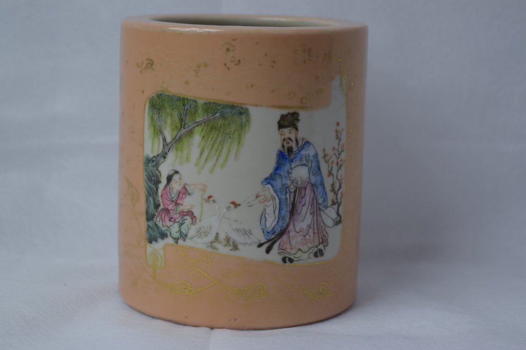 Chinese Famille Rose Brush Pot: Chinese famille rose brush pot with windowed scenes of man and boy in garden and children playing. Early 20th century. Height: 5in. Diameter: 4.5in. Condition: Good