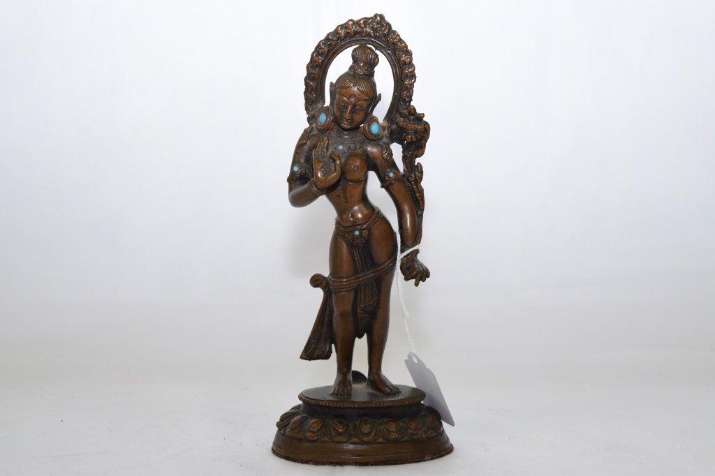 19th C. Nepalese Standing Buddha: In standing position with halo on the back. H: 8.75in.
