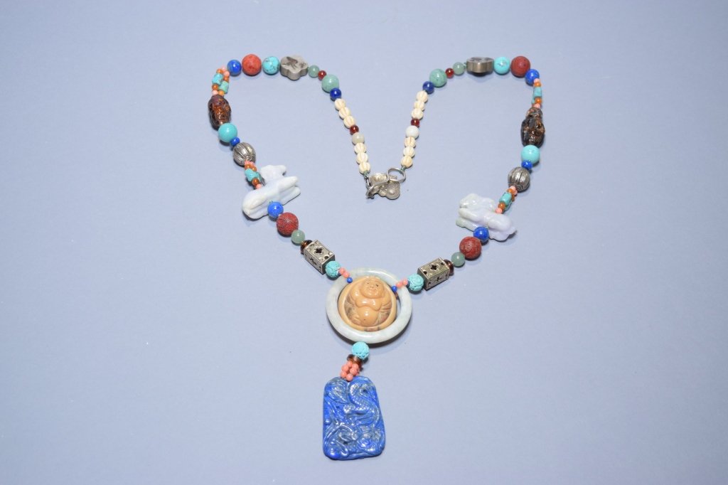 Chinese Jadeite, Lapis Lazuli, Turquoise Necklace: Chinese jadeite, lapis lazuli, turquoise, coral, amber, silver, and stone necklace. D: 19in. Age wear.