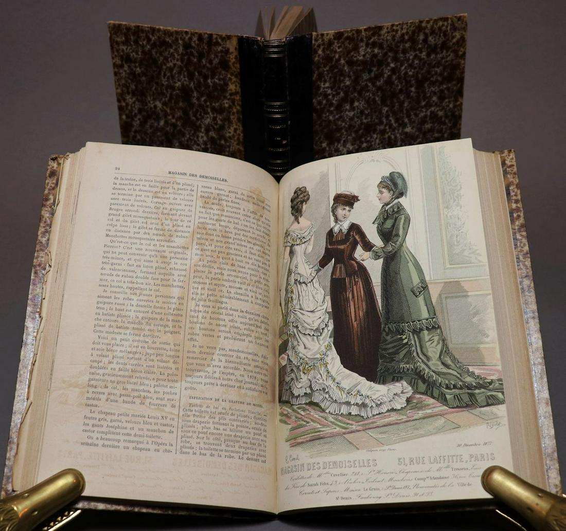 [Color Plates, Women's Fashion, 1877]: MAGASIN DES DEMOISELLES. Paris, 1877. 2 vols, 10" x 6.5". 96, 296; 96, 143, [1] pp. + 32 plates, all but 5 are hand-colored, numerous other plates throughout included in the pagination. Title-page to 
