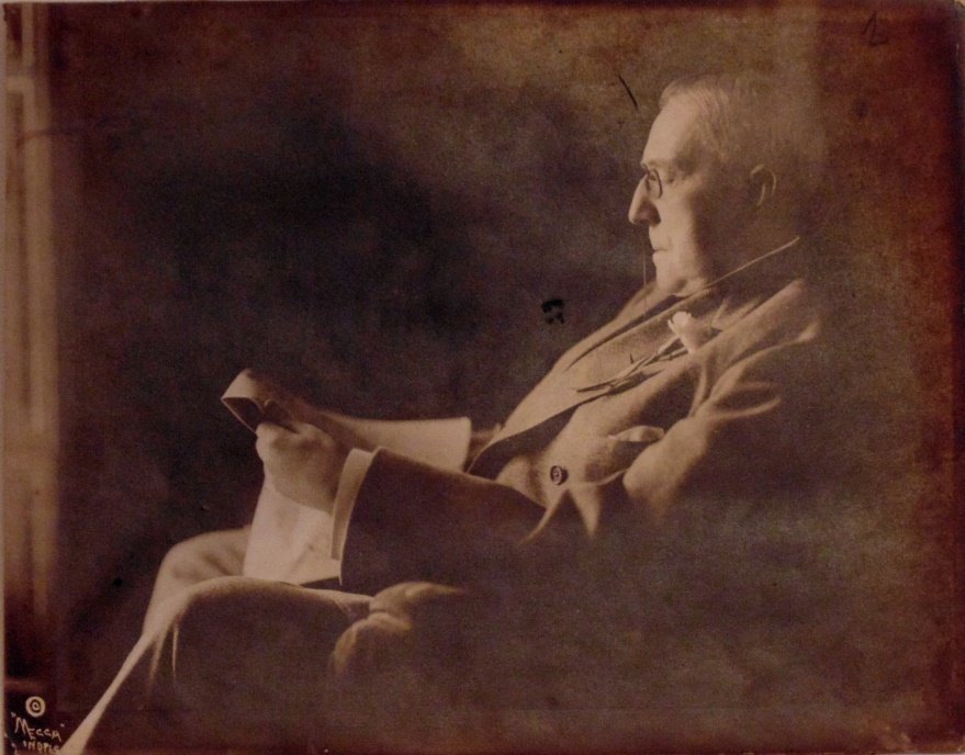 Riley, James Whitcomb. Signed poem and photo: Typed poem, "Sis Rapalye" signed by Riley. Marginal chips, toned, paper somewhat brittle, mounted to board at upper edge as is the photo. Silver print photo of a seated riley reading a paper. Some wri