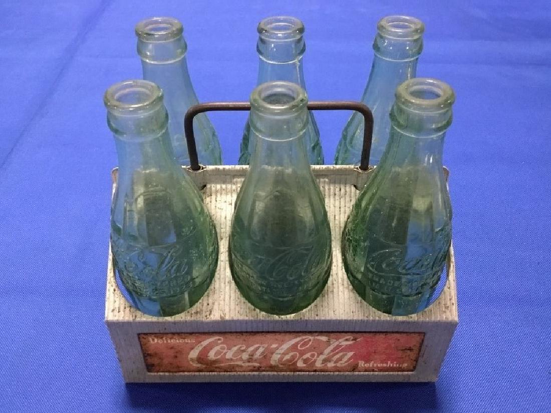 Coca-Cola Bottle carrier and 6 Rare bottles: Aluminum Coca-Cola carrier with 6 bottles from: Huntington, WV, Bluefield WV, Knoxville, TN, Kingsport TN, Baltimore MD, Bowling Green KY