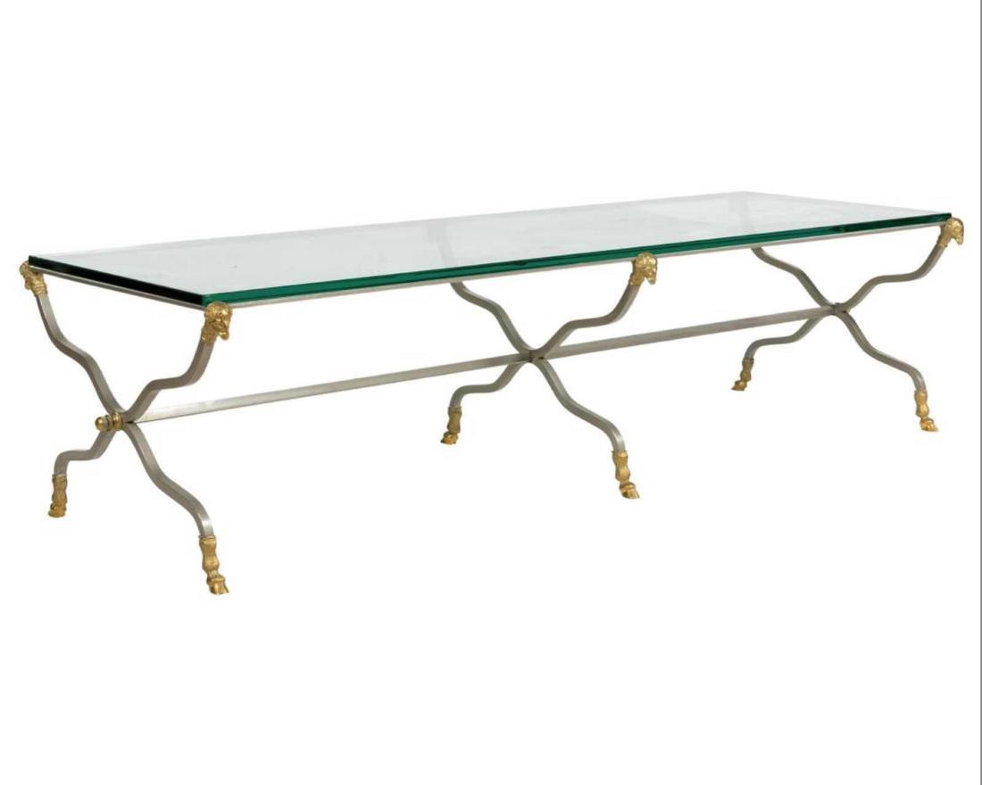 Hollywood Regency Brushed Steel Coffee Table with: Hollywood Regency Brushed Steel Coffee Table with Bronze Rams Head and Hoofed Feet. Dimensions â€“ H: 16" W: 60" D: 22"