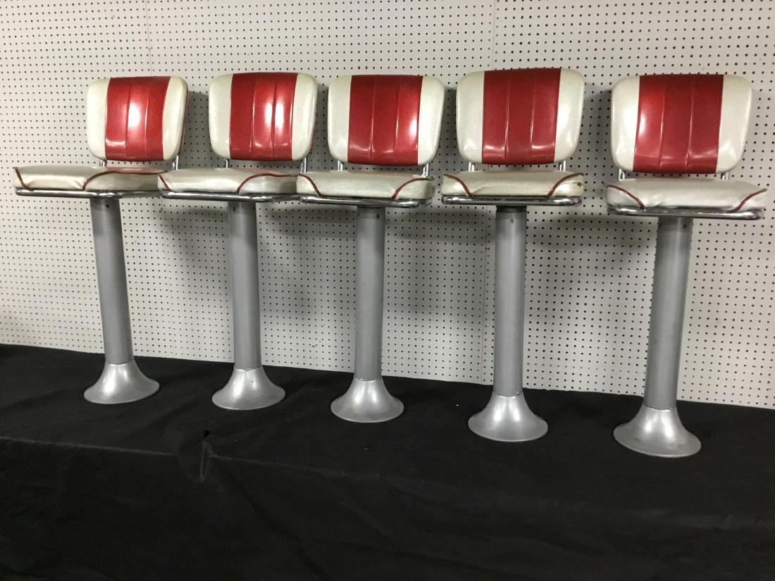 Set of 5 Vintage Soda Shop Bar Stools: Floor mount base, silver and red metallic vinyl cover. Swivel seats, one stool has tear as seen in photos. 30 Inches T.