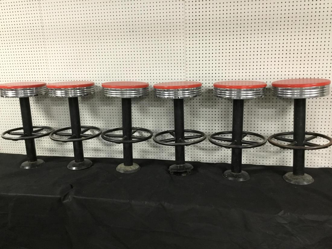 Set of 6 Vintage Soda Shop Counter Stools: Floor mount base, steel foot rests. Red seats with chrome for age and use. 28 Inches T.