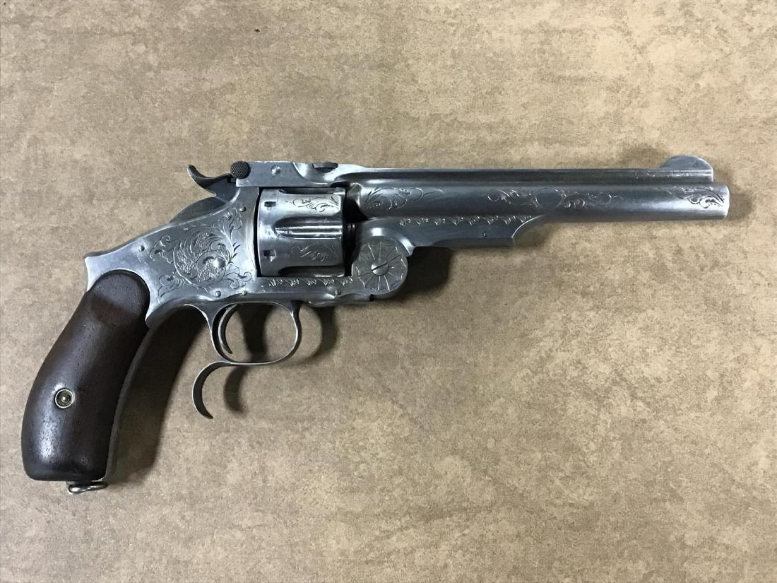 Smith and Wesson Model 3 .44 Cal.: Russian model with longer trigger guard date 1874, engraved 0.75 courage engraving. Number 574, all matching numbers, action works great. Lanyard ring, very good factory markings seen use in the old w