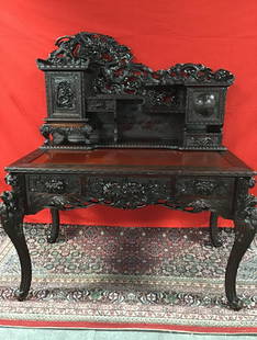 Antique Carved Rosewood Desk: This desk is a fine example of the beautiful craftsmanship from Asia- accompanying 1977 appraisal states desk was made in China about 1860. The desk is heavily carved rosewood with dragons, flowers an